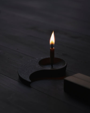 Candle holder with lit candle from Nezen Box Set by Iwata on a wooden background
