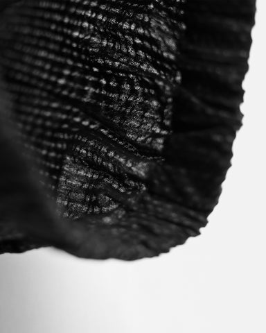 Up-close of Samue Loungewear Top Sleeve by Iwata on a light gray background