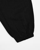 Up-close of Samue Loungewear Bottoms cinched leg hole by Iwata on a light gray background