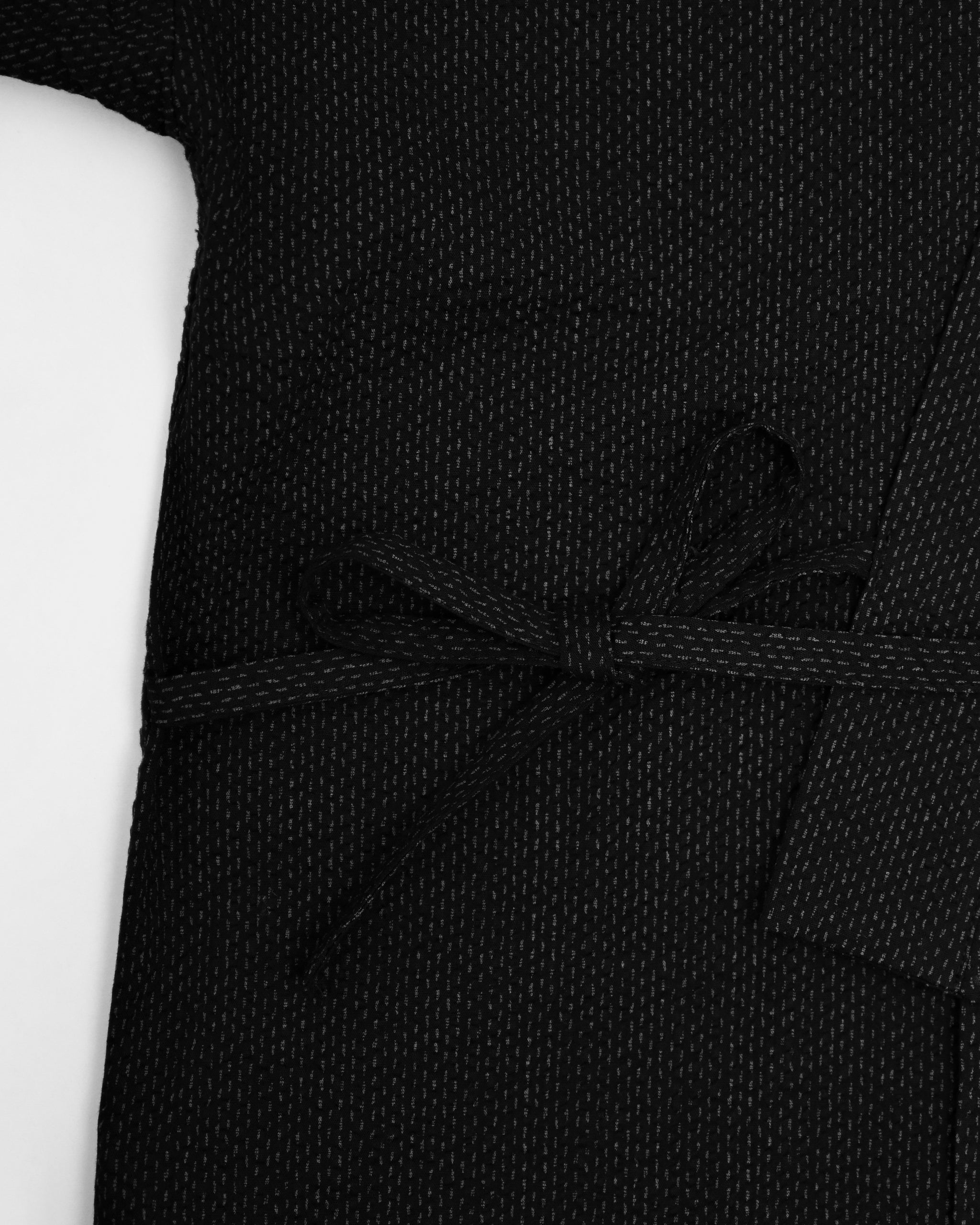 Up-close of Samue Loungewear Top exterior tie by Iwata on a light gray background