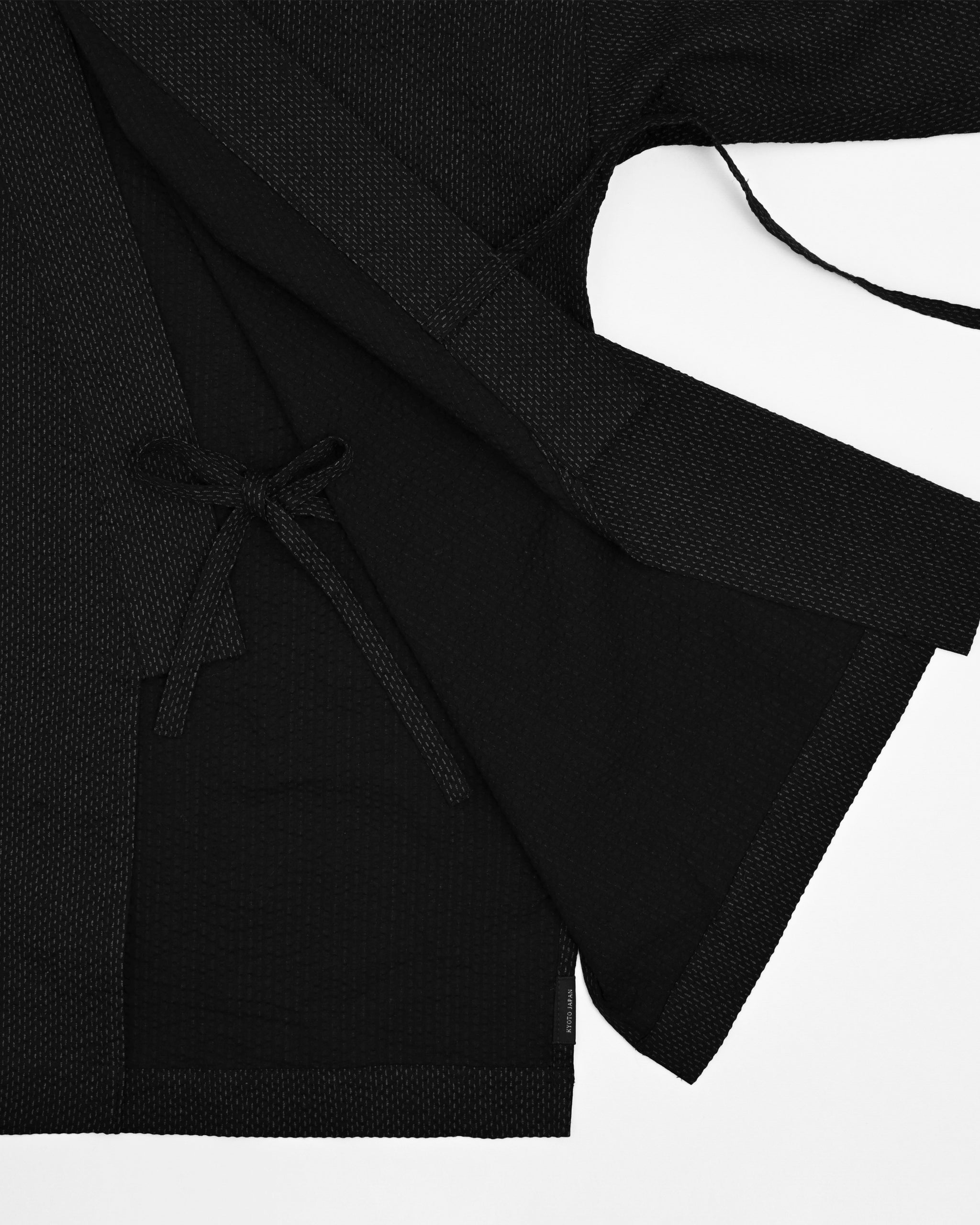 Up-close eof Samue Loungewear Top interior tie by Iwata on a light gray background