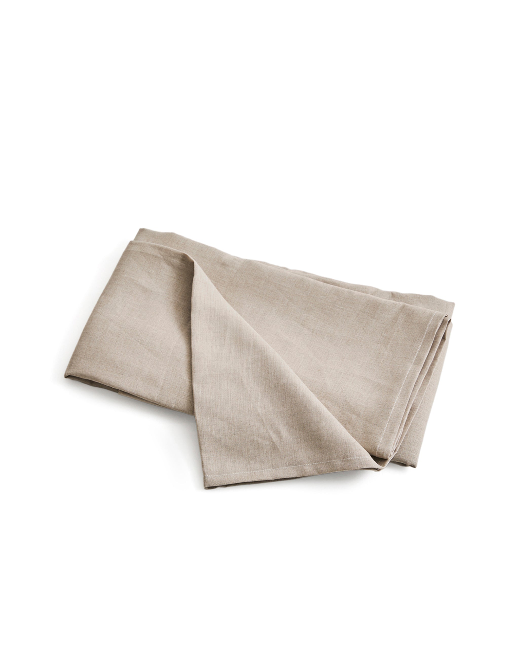 Folded unbleached linen flat sheet on a white background