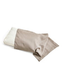 White pillow with unbleached linen pillow sheet on a white background