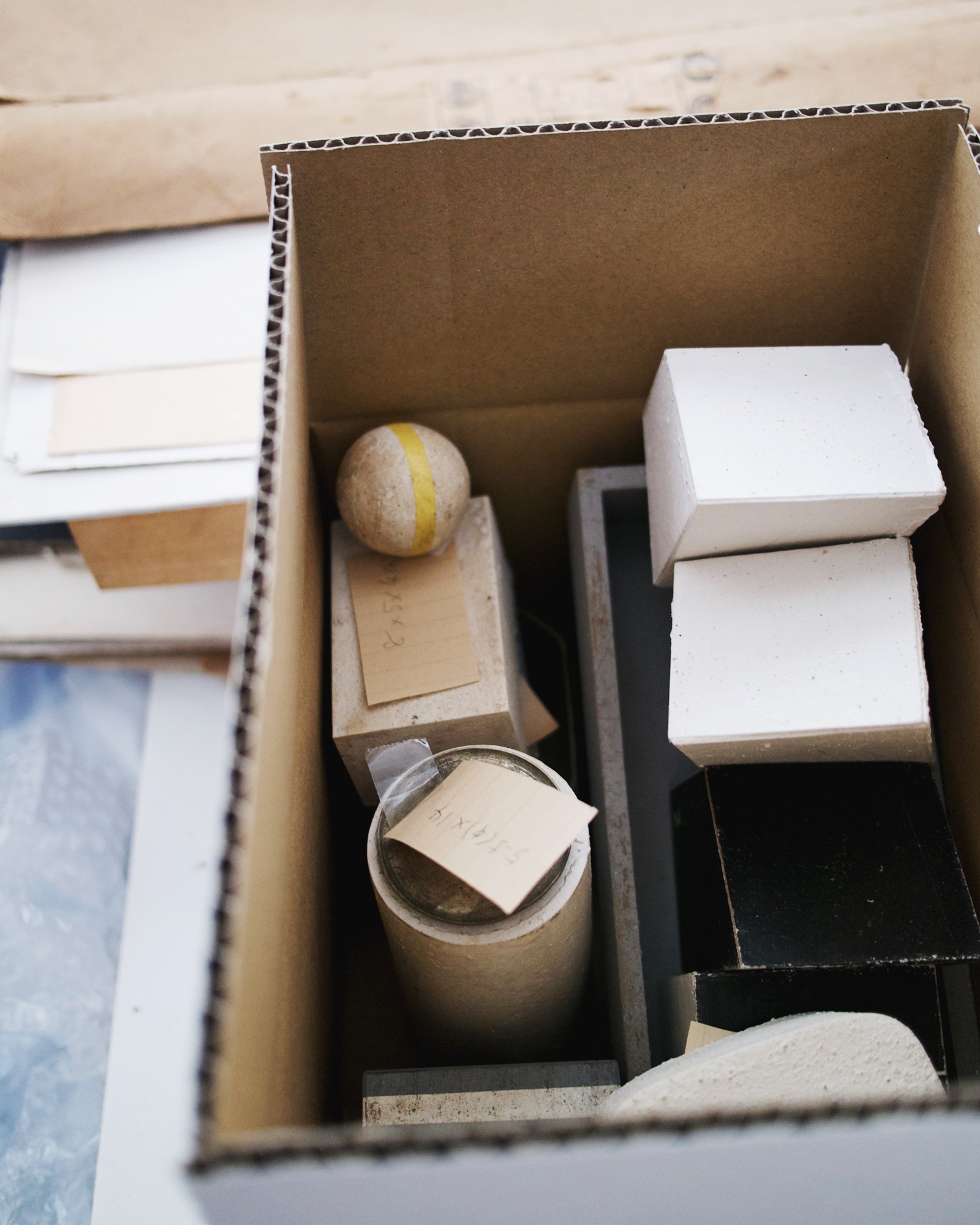 Top down shot of cardboard box filled with recycled paper forms