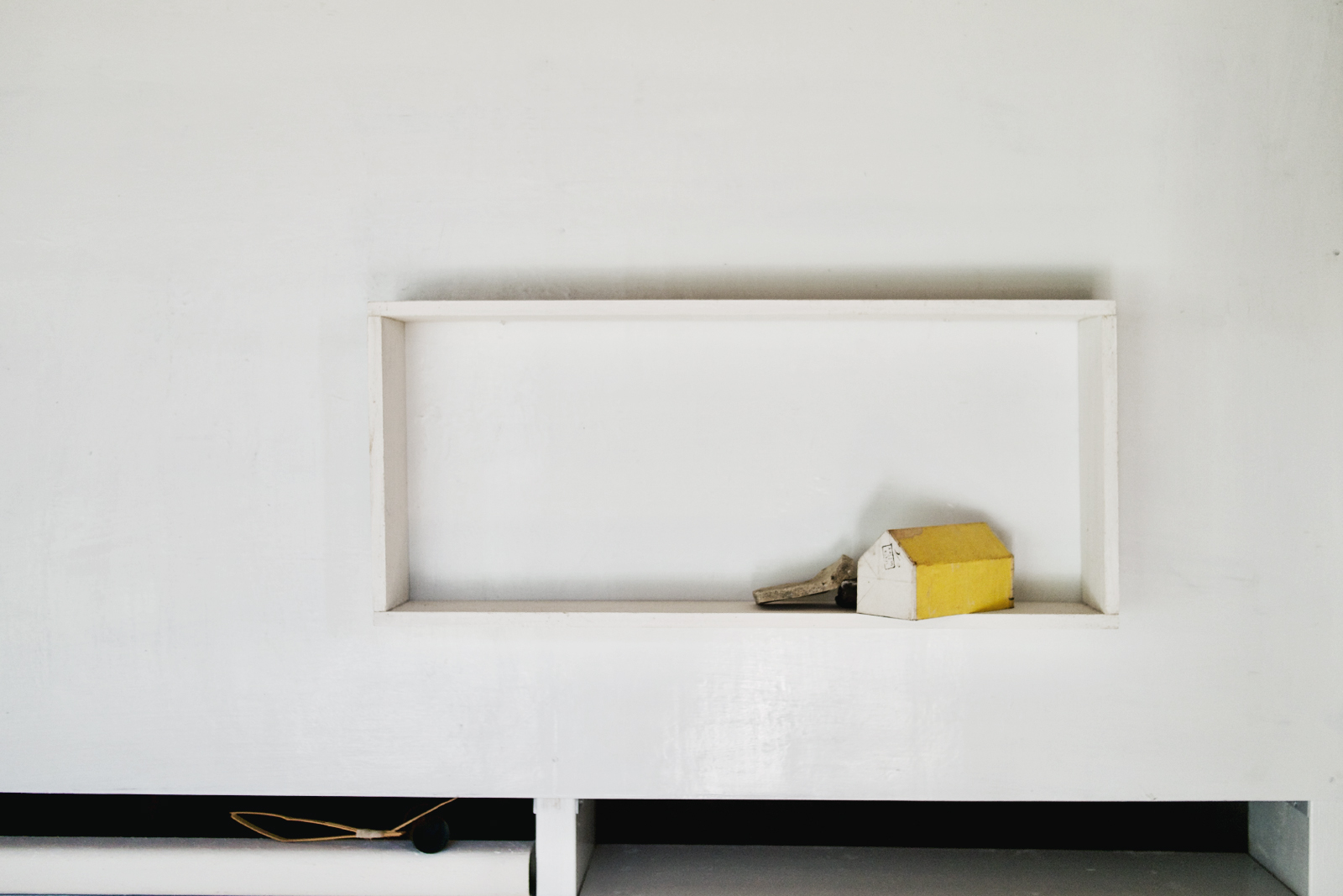 House with yellow roof by Michik oIwata installed in a white wall hanging frame in the Iwatas' annex gallery