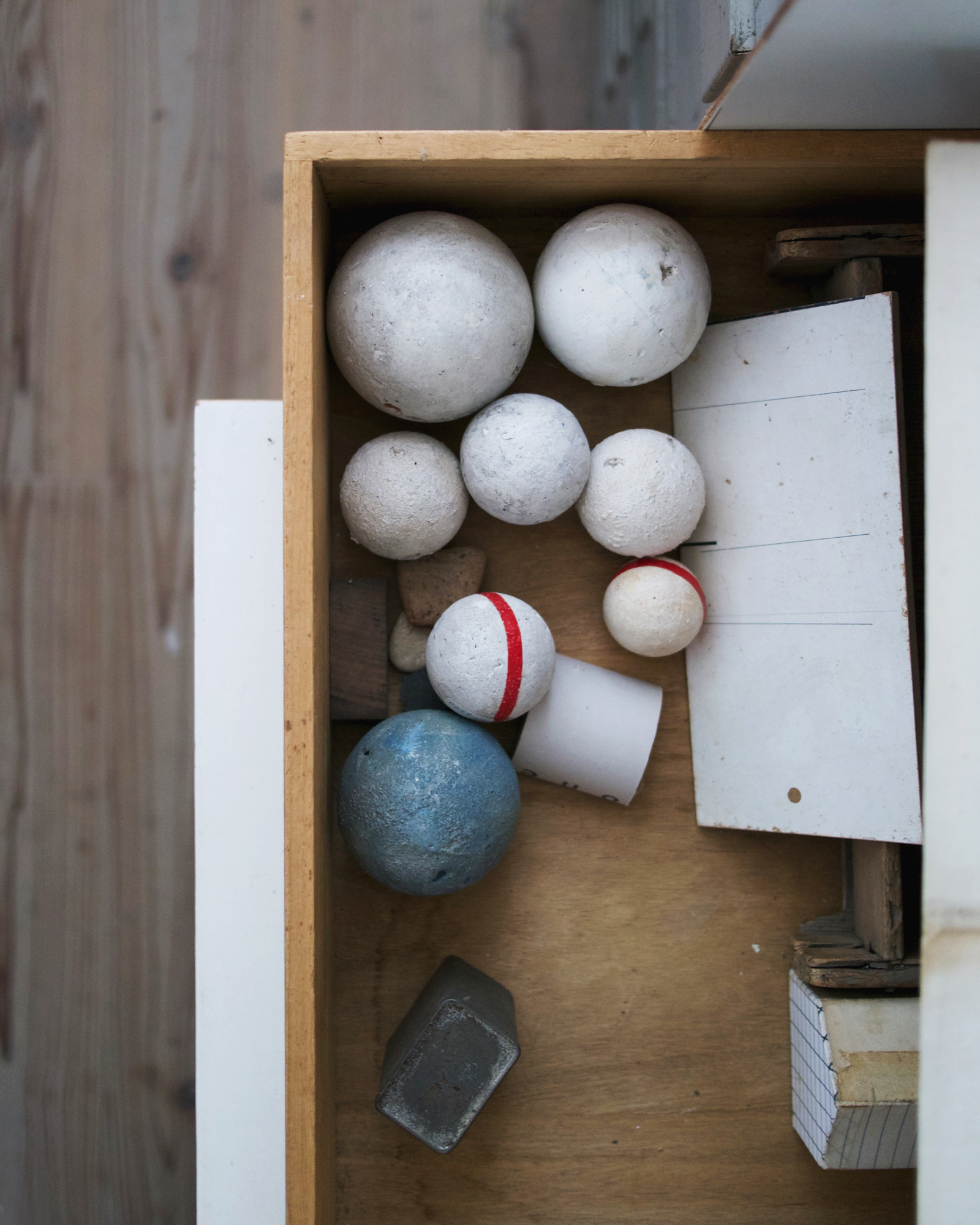 Drawer full of white and blue hand formed and painted spheres