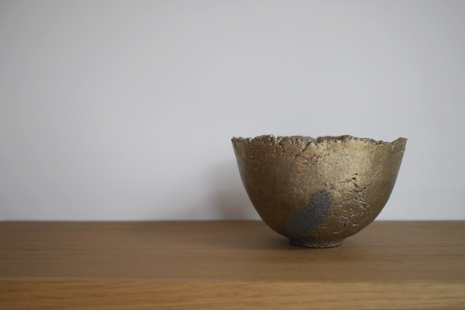 Flared gold chawan on display at an exhibition