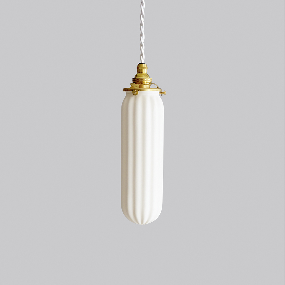 Hanging pill-shape, ridged pendant lamp by Tobimatsu Toki on a gray background