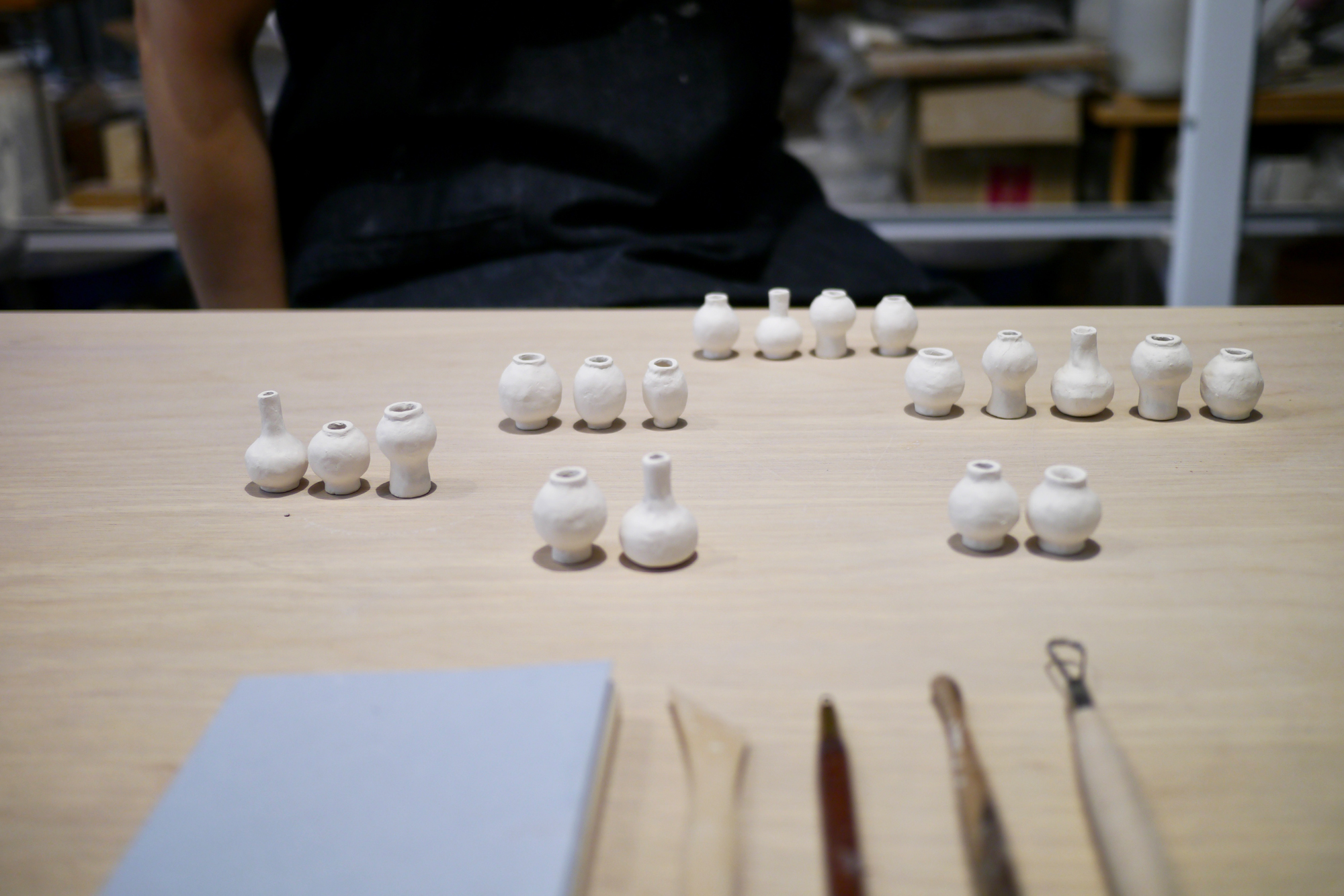 Dani Sujin Lee Studio x Nalata Nalata Mini Group Vase Collaboration - cluster of hand form vases not yet fired with tools in the foreground