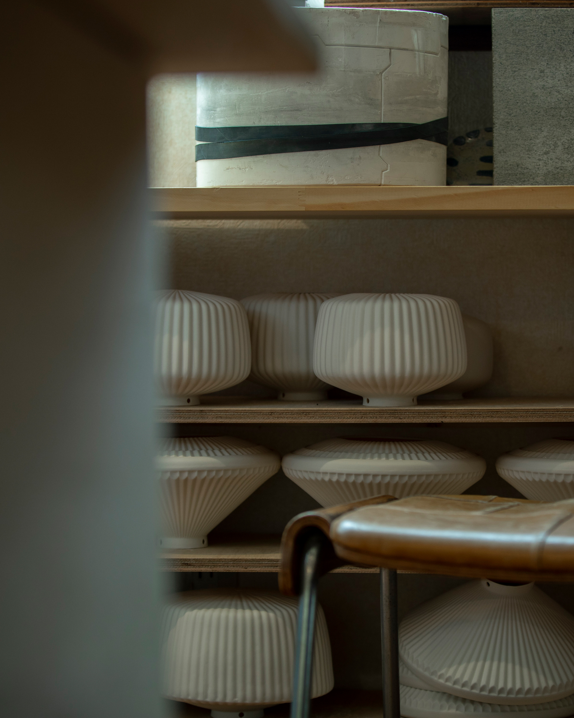 porcelain shades resting on a shelf at Tobimatsu Toki's studio