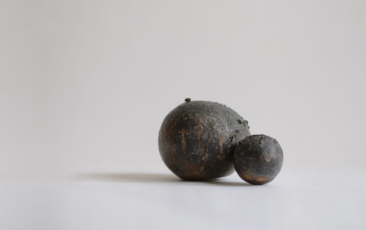 A woodfired ceramic piece of two stone vases attached by Keisuki Iwate