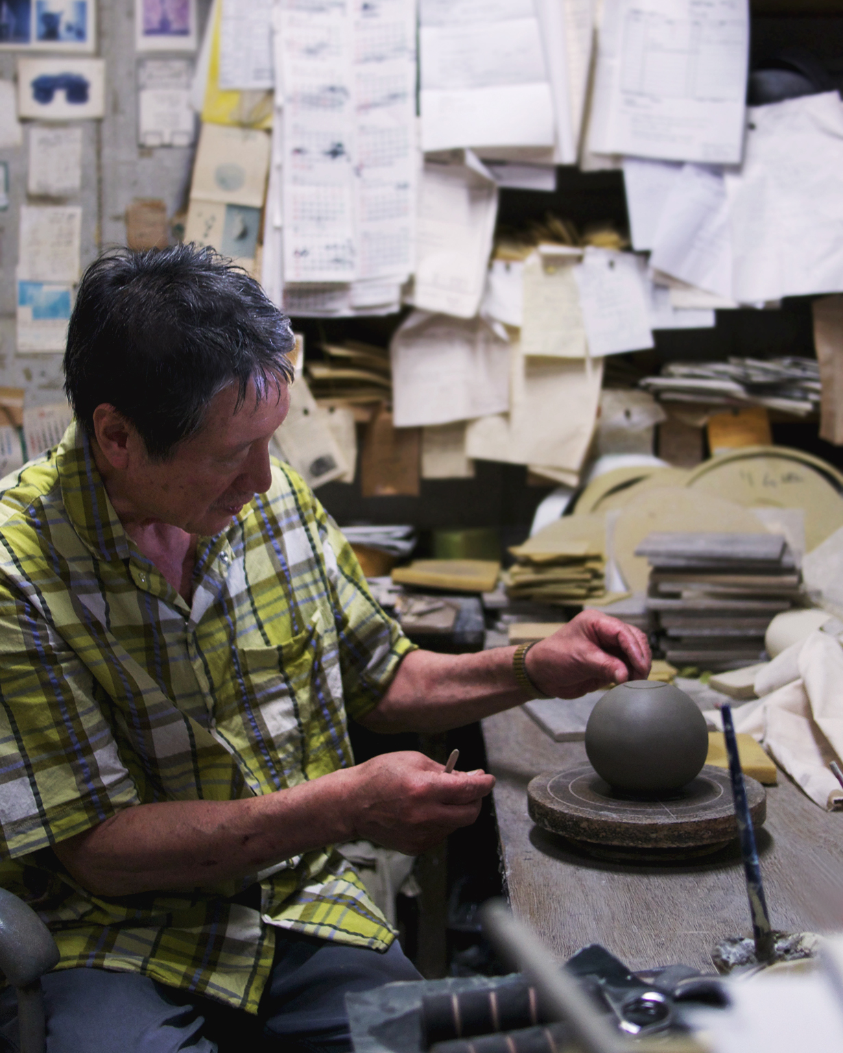 Keisuke Iwata in his ceramics studio building a teapot