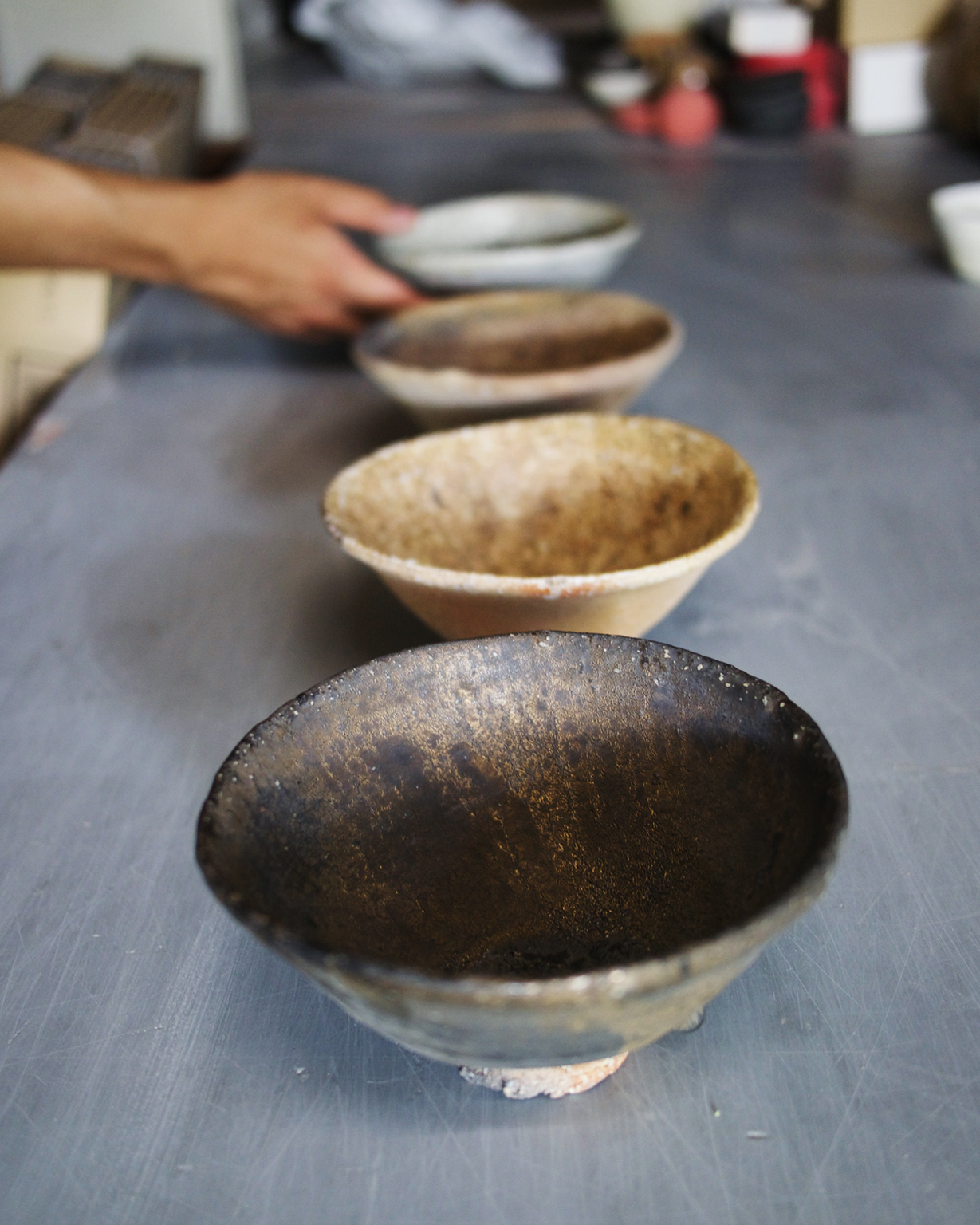 Ceramic chawans made by Keisuke Iwata lined up in a row