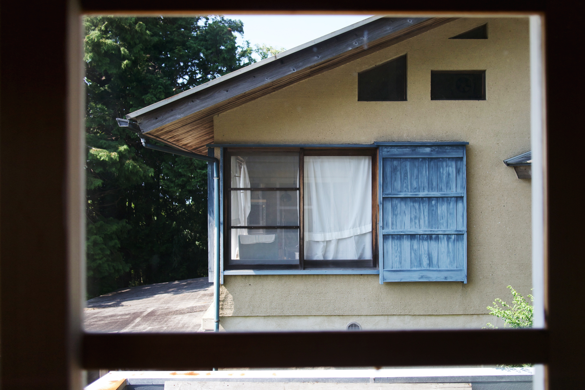 View of Keisuke and Michiko iwata's home through a window from their small gallery space