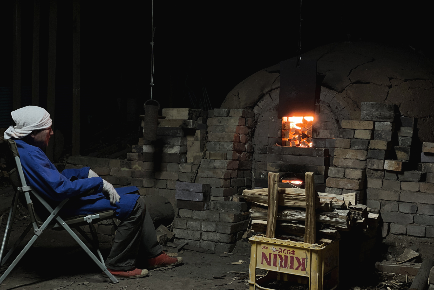 Keisuke Iwata relaxing by the Anagama kiln in a chair