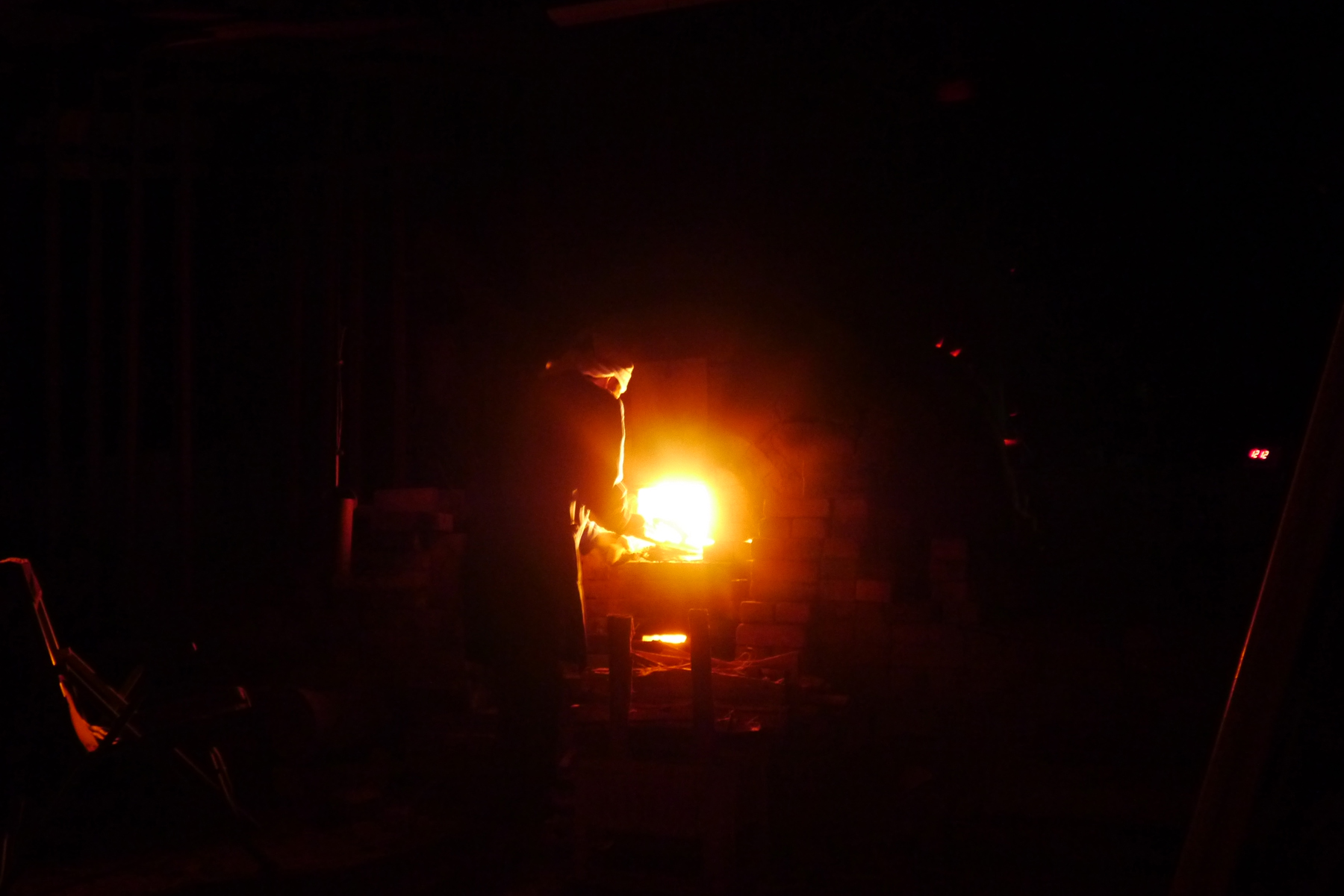 Abstract round red and orange fire ball in center of image with silhouette of Keisuke Iwata in front of it