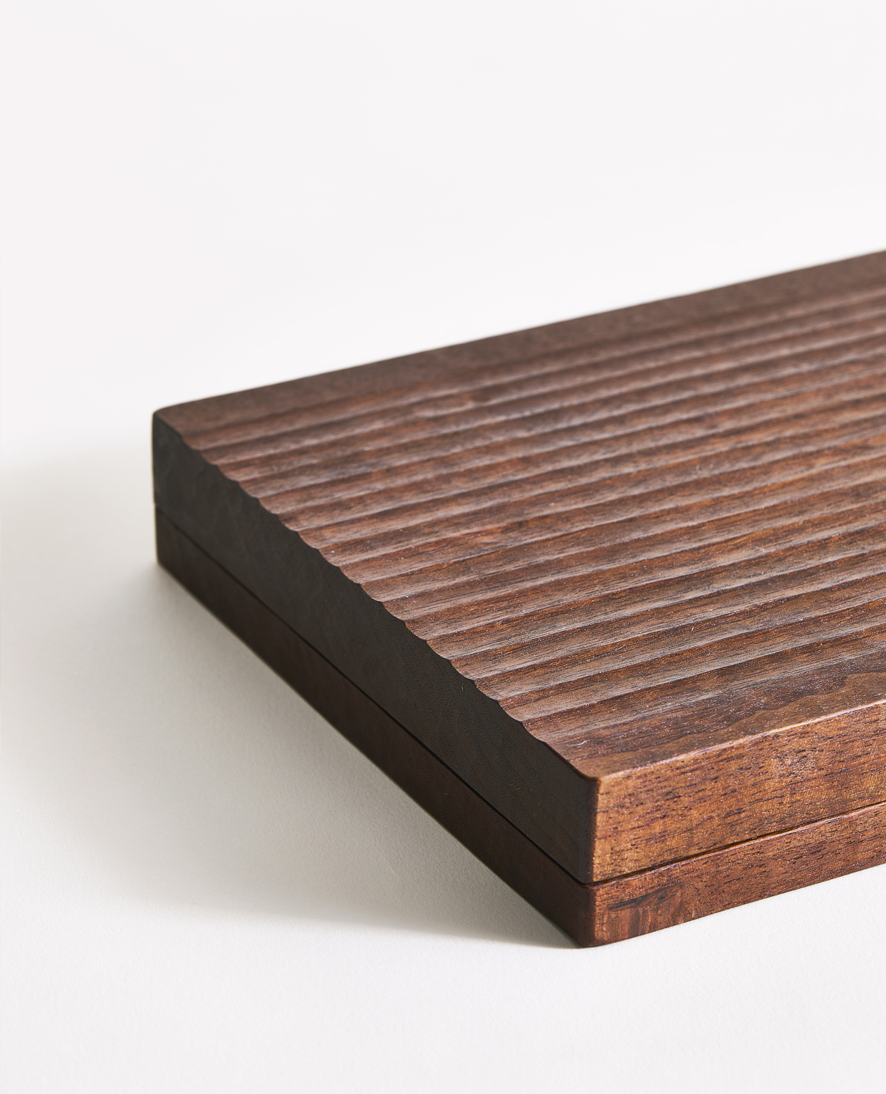 Textured deep brown monograph photocase by Ryuji Mitani on a gray background