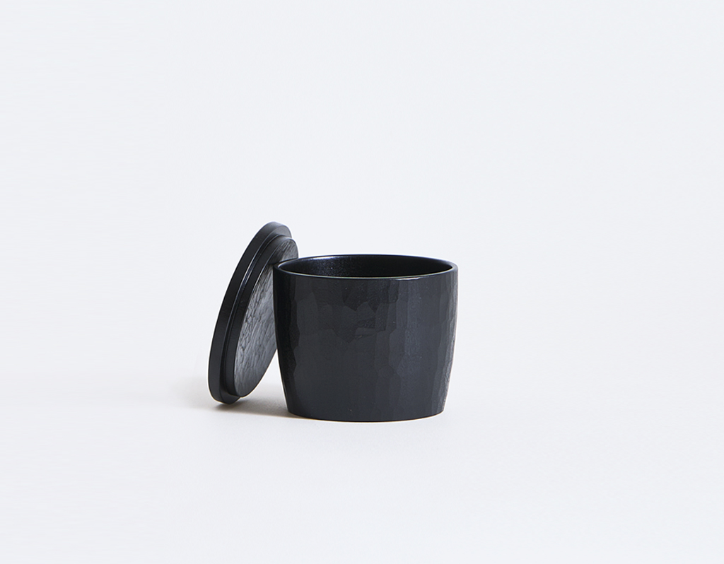 Black tea cup with lid leaning on left side by Ryuji Mitani
