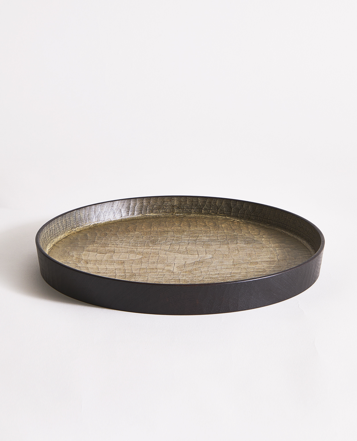 Wooden tray with black trim and beige interior by Ryuji Mitani on a gray background