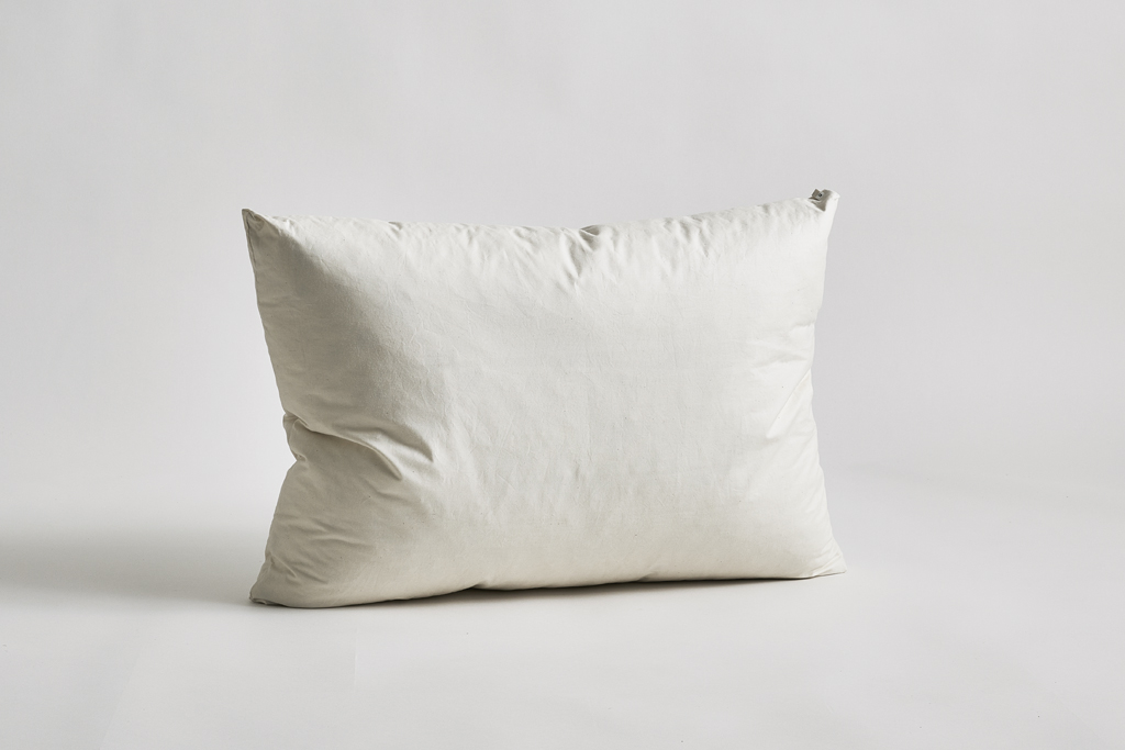Down and feather pillow by Iwata on a gray background