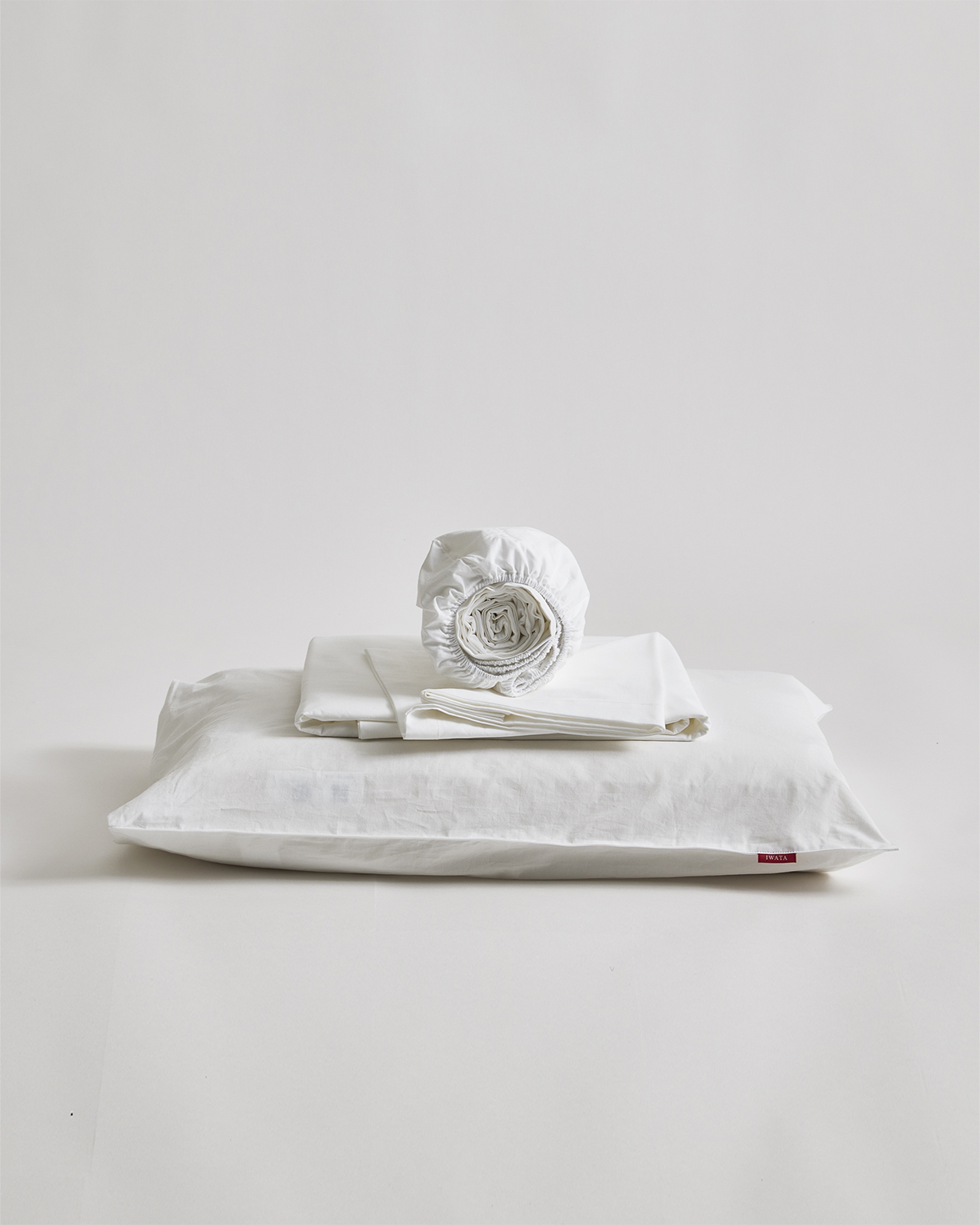 Cotton sheet set by Iwata on a gray background