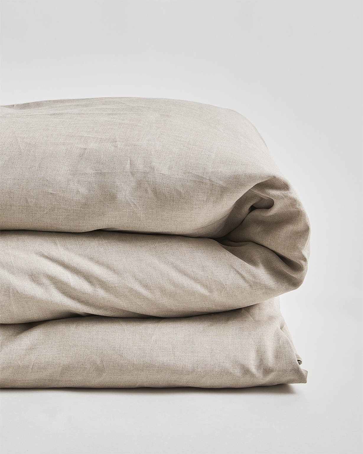 Up-close of unbleached linen duvet cover by Iwata on a gray background