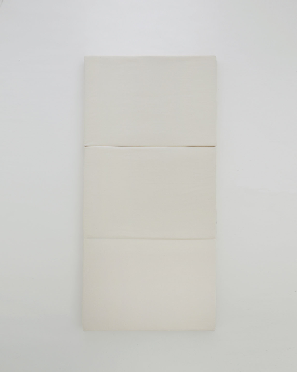 Futon Floor Pad laid flat by Iwata on a gray background