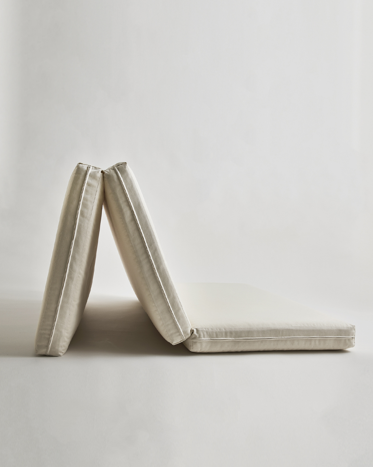 Tri-fold Floor Pad by Iwata on a gray background