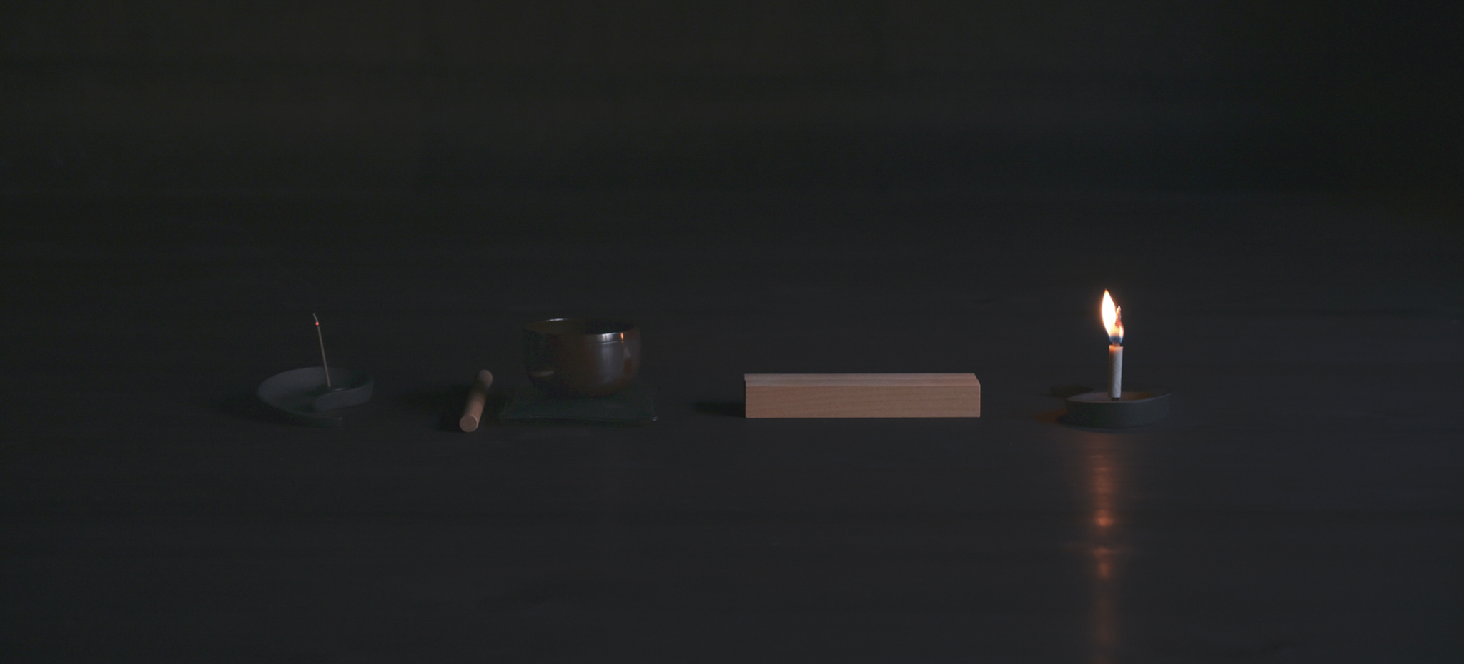 Nezen Box Set Items by Iwata set in a line on the floor on a black background.